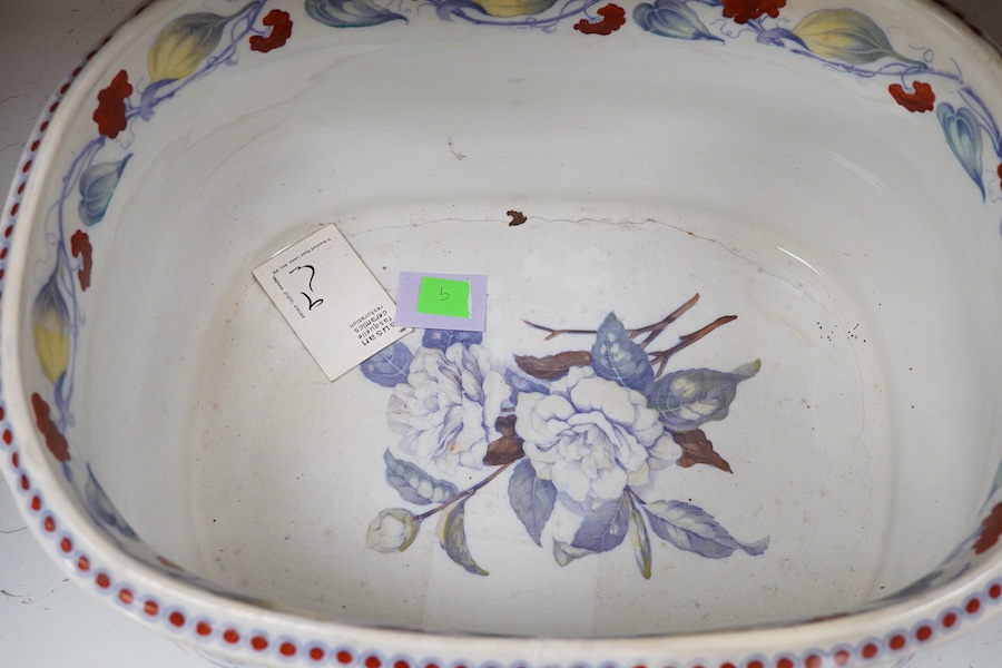 A 19th century Staffordshire pottery two handled footbath, (repaired), 50cm wide